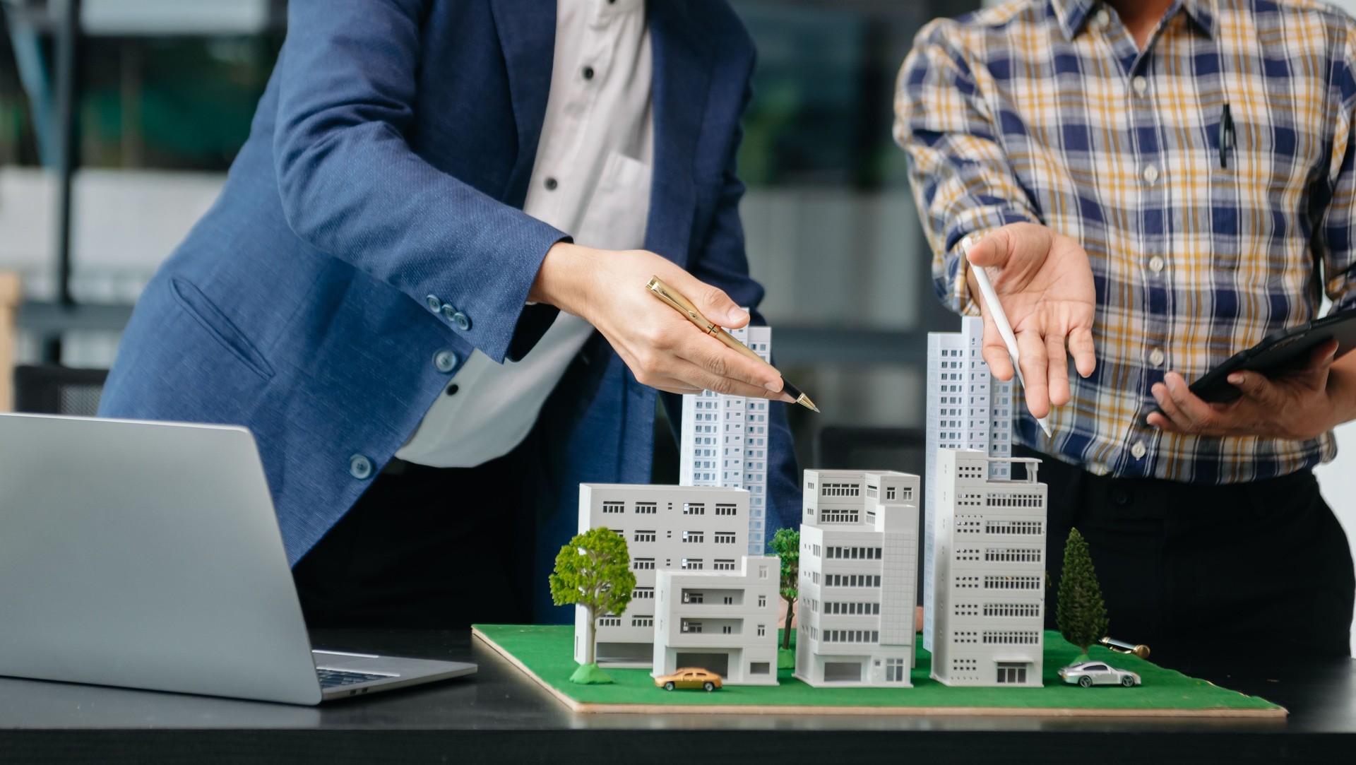 balancing the property sector The real estate agent is explaining the house style to see the house design and the purchase agreement. house city
